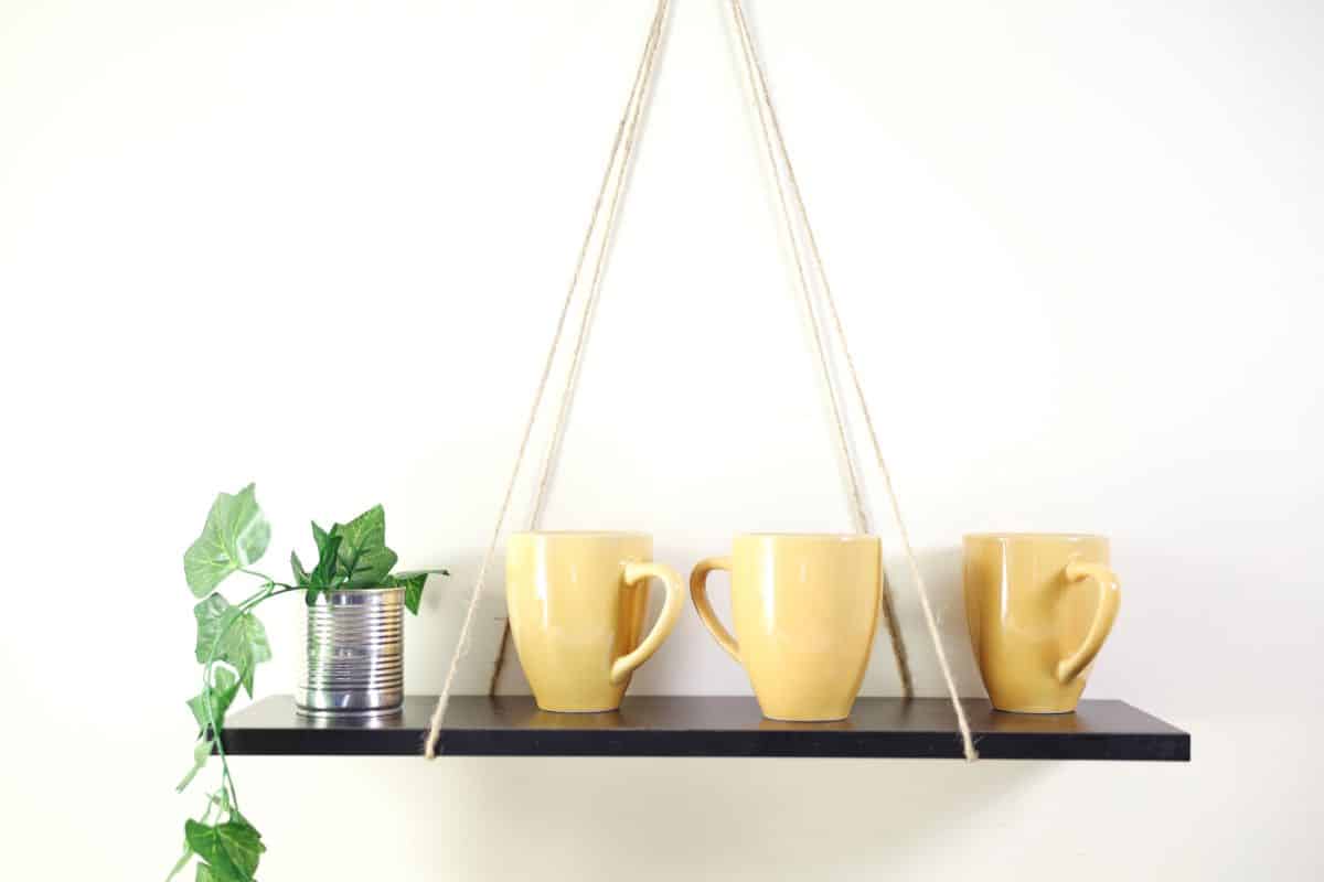 Floating shelfs with cups and a plant.